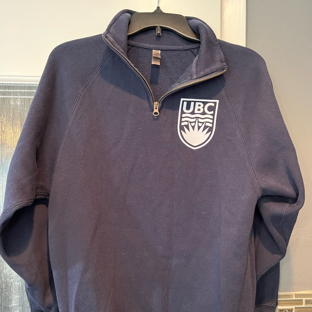 UBC light navy blue sweatshirt with 1/4 zip.